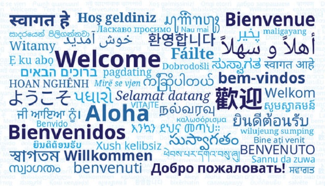  A colorful poster with the word "Welcome" written in various languages, symbolizing inclusivity and a multicultural environment.