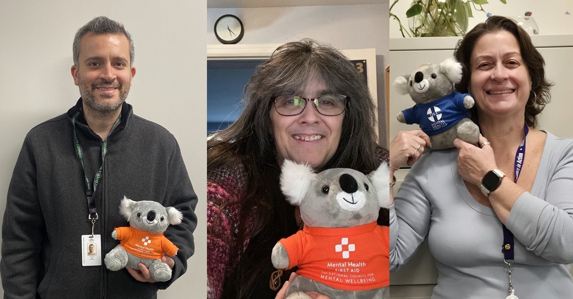 A photo of three trainers holding koala mascots representing mental health first aid, emphasizing training and community support.