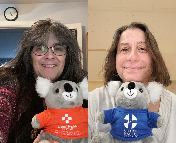 A photo of two trainers holding koala mascots representing mental health first aid, emphasizing training and community support.